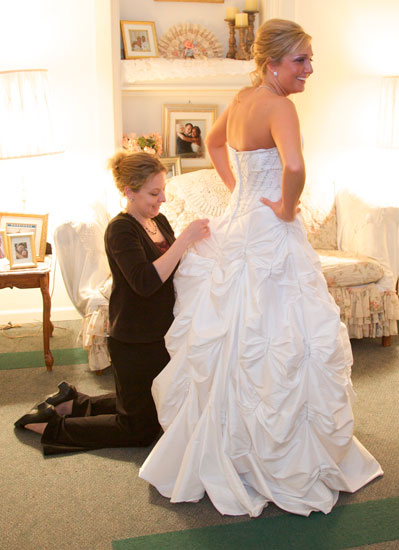 Tiffany sews up Logan's bustle in Hamilton's VIP room. Copyright Warmowski Photography.