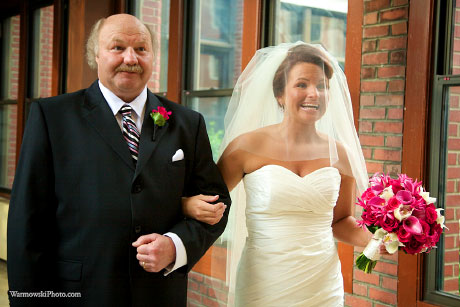 Emily holds her bouquet as she and her father wait to walk to the sanctuary.