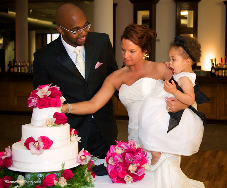 Flowers adorn Emily & Jk's cake as their daughter Ava asks for a bite, too.