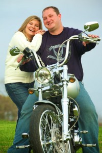 Elisha & Bob Lonergan on motorcycle.