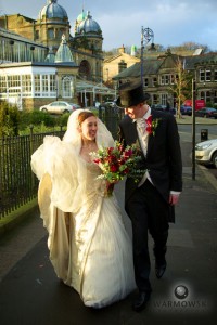 Bride & Groom walk near old opera house in Buxton, UK