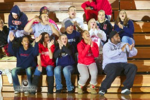 MacMurray College students clap and cheer during a basketball game, Warmowski Photography.