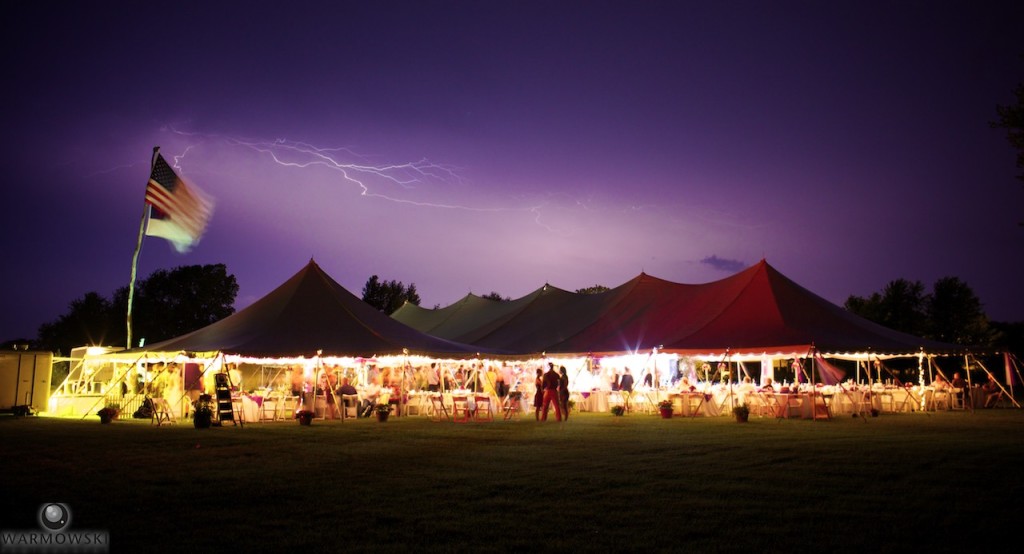 Summer wedding in Carrollton Illinois of Hannah & Joe with lightning from a passing storm. Image on Signature Rentals.