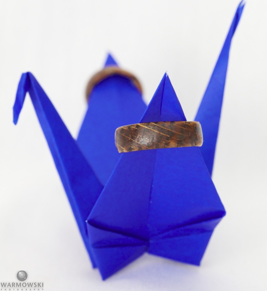 Shiori carved her and Brett's wedding rings on lucky crane origami.