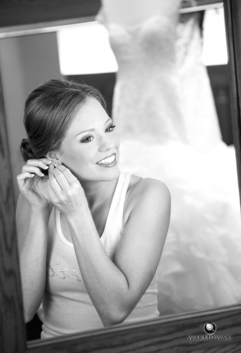 Amanda getting ready to put on dress, Jacksonville Country Club. Photo by Steve & Tiffany of Warmowski Photography.