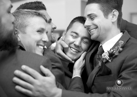 Nick gets a group hug from groomsmen, wedding at the Jacksonville Country Club. Photo by Steve & Tiffany of Warmowski Photography.