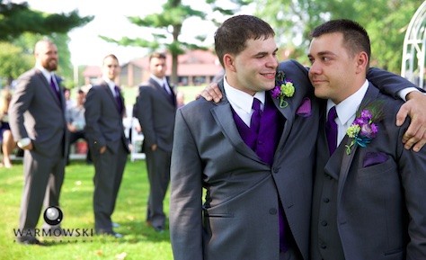 Best Man Clay gives Groom Nick a hug as they wait for the start of the outdoor wedding ceremony at the Jacksonville Country Club. Photo by Steve & Tiffany of Warmowski Photography.