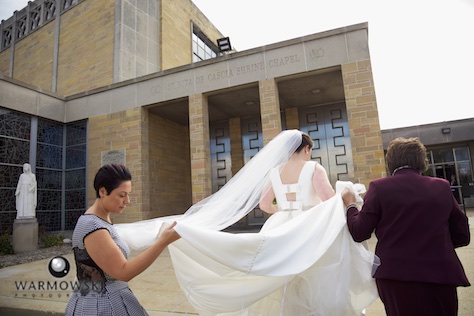 Elizabeth arrives at St. Rita of Cascia Shrine Chapel in Chicago for ceremony. Accompanied by her mother and wedding planner. Wedding photography by Tiffany & Steve & Warmowski.