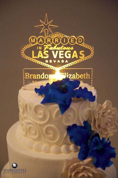 Lizzie & Brandon's wedding reception at The Elks lodge in Jacksonville. Their cake had a Las Vegas sign, to recognize their wedding ceremony earlier in the year. Wedding photography by Steve of Warmowski Photography.