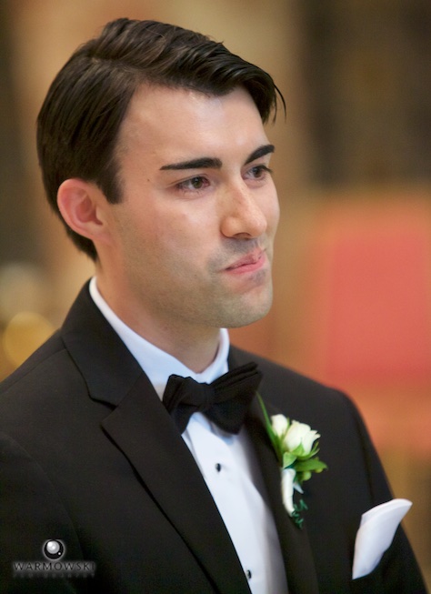 Daniel watches Elizabeth come down the aisle, ceremony at St. Rita of Cascia Shrine Chapel in Chicago. Wedding photography by Tiffany & Steve & Warmowski.