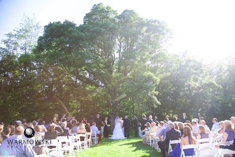 The wedding ceremony site was beneath the shade of a massive oak tree Ñ perfect way to beat the June heat. Wedding photography by Tiffany & Steve of Warmowski Photography.