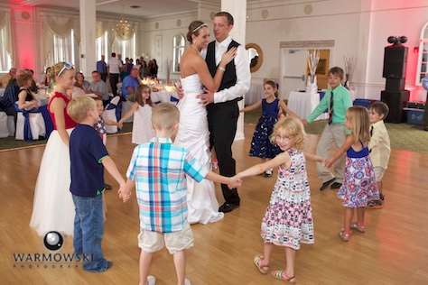 DJ Troy Armstrong loves to work children into the events of the day, including encircling Amber & Ryan during their first dance. Wedding photography by Steve & Tiffany Warmowski