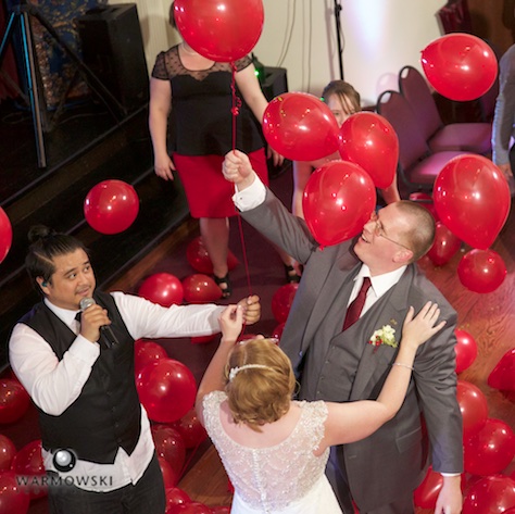 As a special treat, when Fun DMC played a mashup of Nena's 99 Luftballons, the dance floor was filled with red balloons. Amy & Ryan's wedding reception at the Hoogland Center for the Arts in Springfield. Wedding photography by Tiffany & Steve of Warmowski Photography.