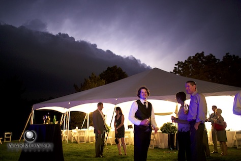 A storm front made guests choose to stick with the meal tent, the party tent or inside the house. Wedding of Amy & Brad at the bride's family home in rural Springfield. Wedding photography by Tiffany & Steve of Warmowski Photography.