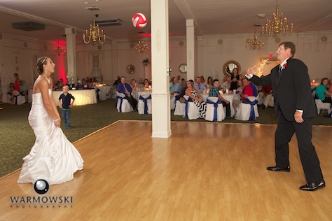 Amber and father practice volleyball hits, just like they did so many times when she was growing up. Wedding photography by Steve & Tiffany Warmowski