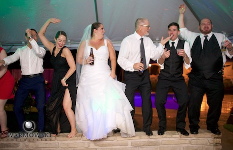 As the rain poured, the party fueled by Music Source Professional Disc Jockey Service went on in the party tent next to the house. Wedding photography by Tiffany & Steve of Warmowski Photography.