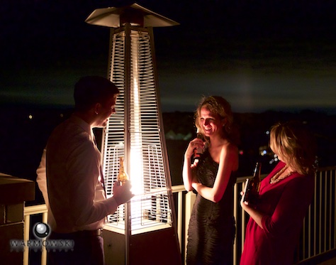 Guests enjoying a heater and the fall weather, balcony at Crystal Tree Country Club, Orland Park. Wedding photography by Tiffany & Steve & Warmowski.