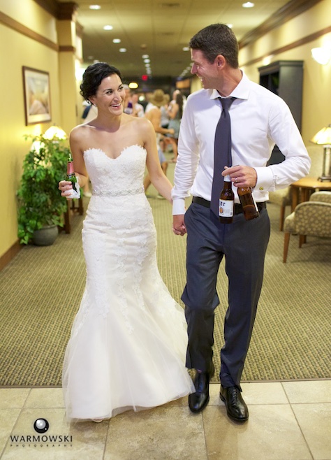 Emi & Daniel lead their friends to the hotel bar, post-party at the Inns at Geneva National. Wedding photography by Steve & Tiffany Warmowski