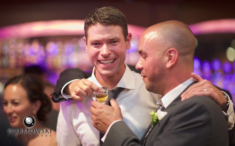 Daniel enjoys the evening with friends, post-party at the Inns at Geneva National hotel bar. Wedding photography by Steve & Tiffany Warmowski