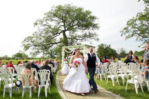 Sarah & Brandon walk down the aisle following their ceremony at the pergola at Buena Vista Farms rural Jacksonville Photo by Steve & Tiffany Warmowski 