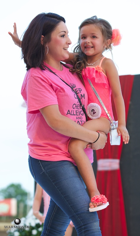 Princess contestant Alleigha King gets a boost from mom Melissa Flores during bathing suit portion of contest.