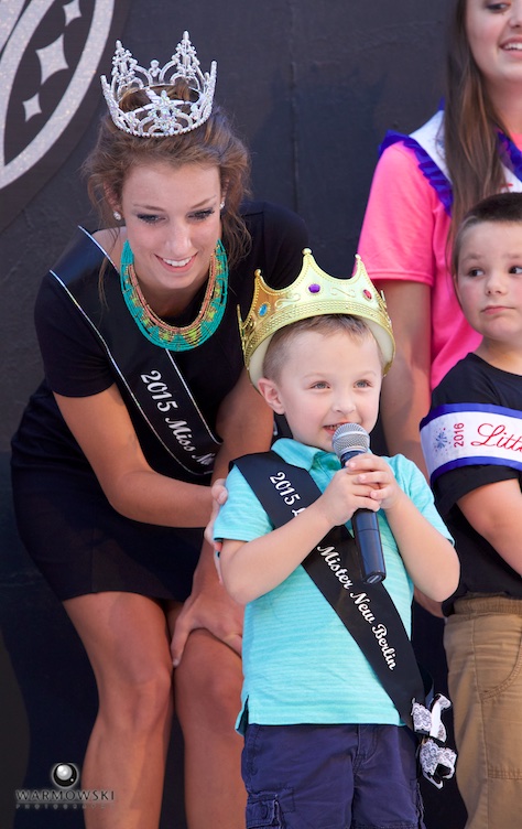 Little Mister New Berlin gets control of microphone during well wishes from visiting royalty.